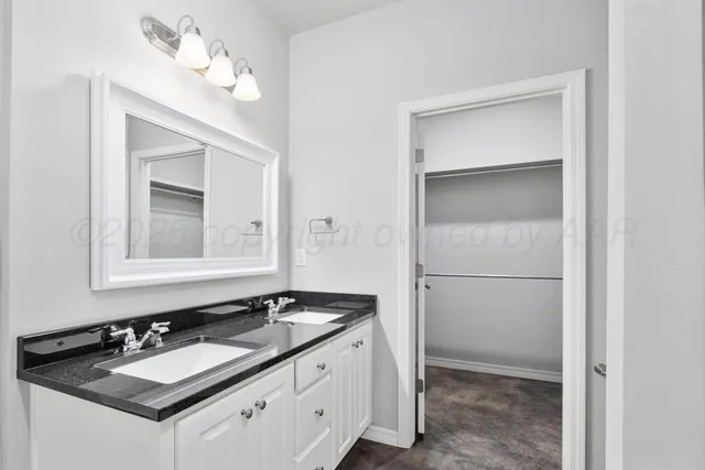 a bathroom with a sink vanity and a mirror