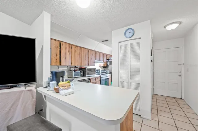 a room with a sink a flat screen tv and next to a window