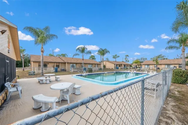 a view of a swimming pool with outdoor seating