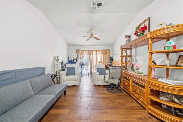 a living room with furniture or couch and a book shelf