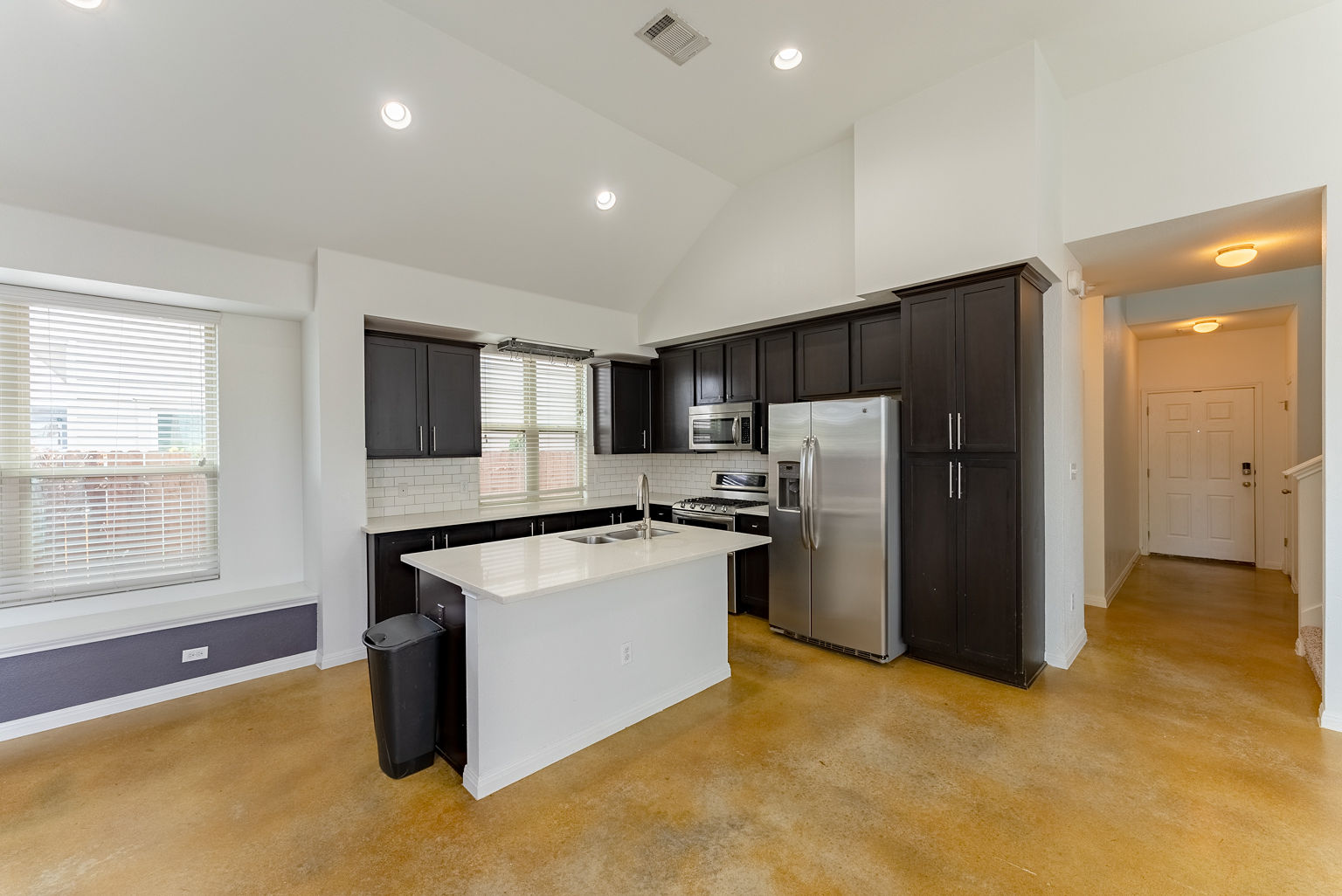 4514 Senda Lane Austin, TX 78725 - Photo 11 of 25 a kitchen with refrigerator and window