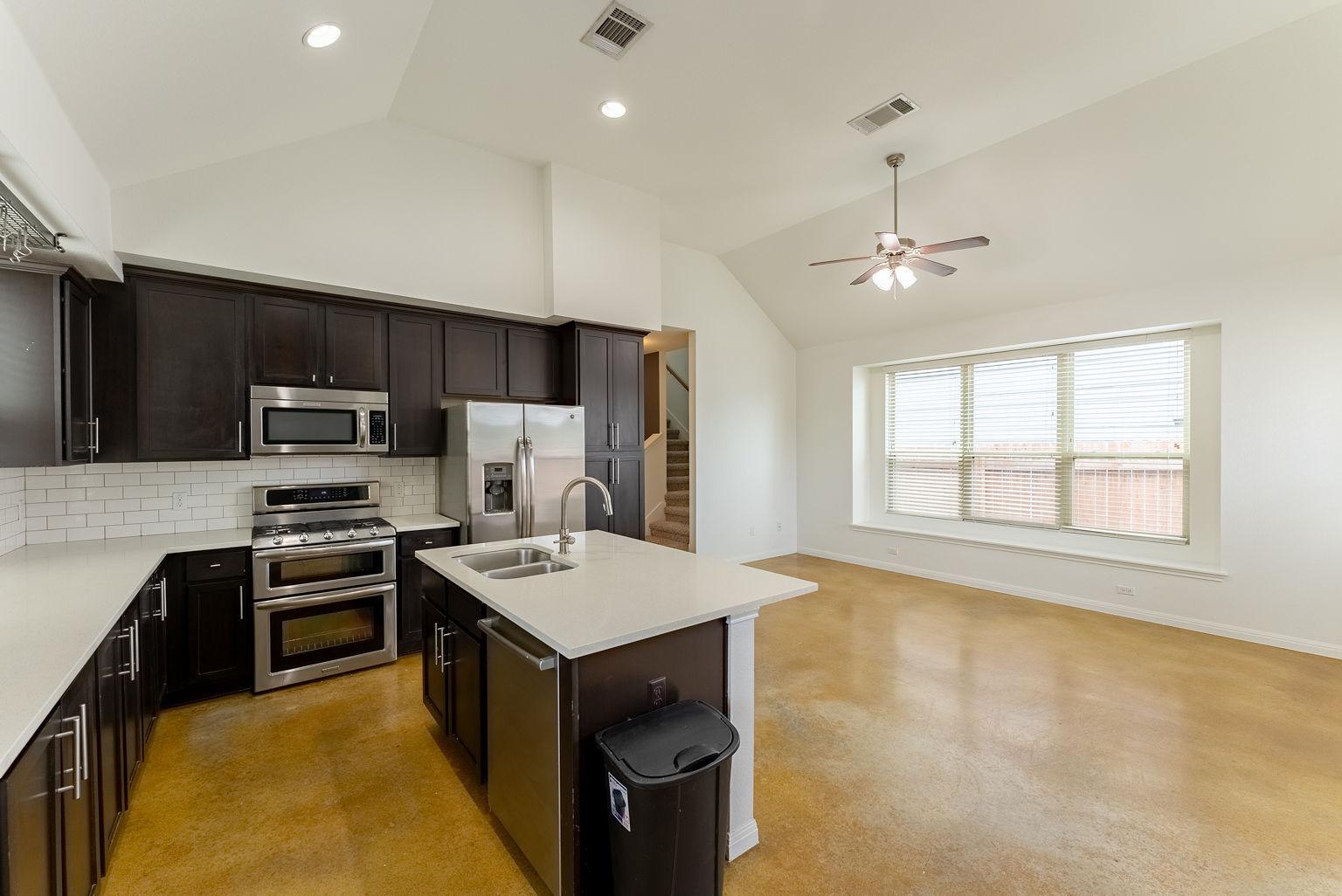 4514 Senda Lane Austin, TX 78725 - Photo 12 of 25 a kitchen with stainless steel appliances granite countertop a sink stove and refrigerator