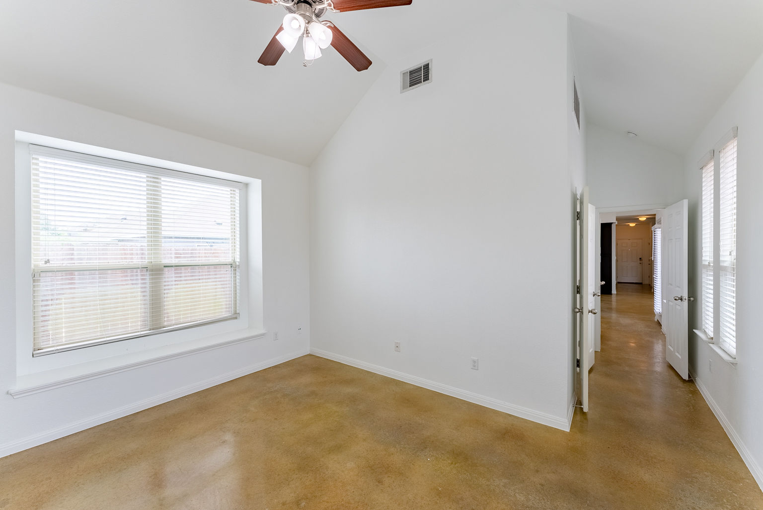 4514 Senda Lane Austin, TX 78725 - Photo 14 of 25 an empty room with a empty space and windows