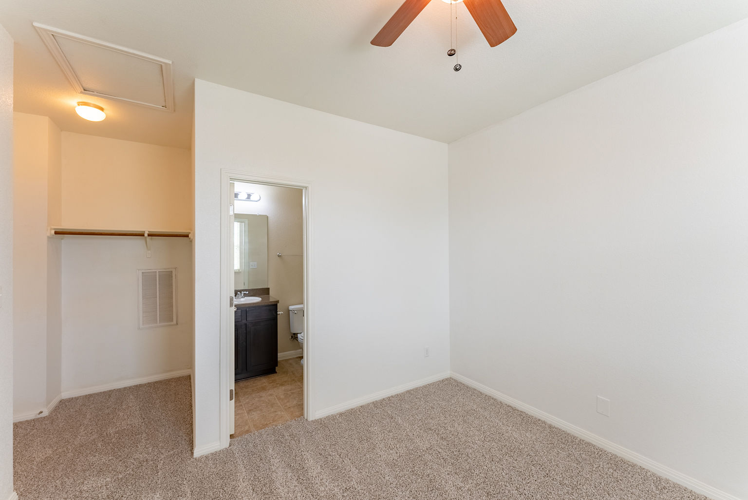 4514 Senda Lane Austin, TX 78725 - Photo 19 of 25 an empty room with closet and a chandelier fan