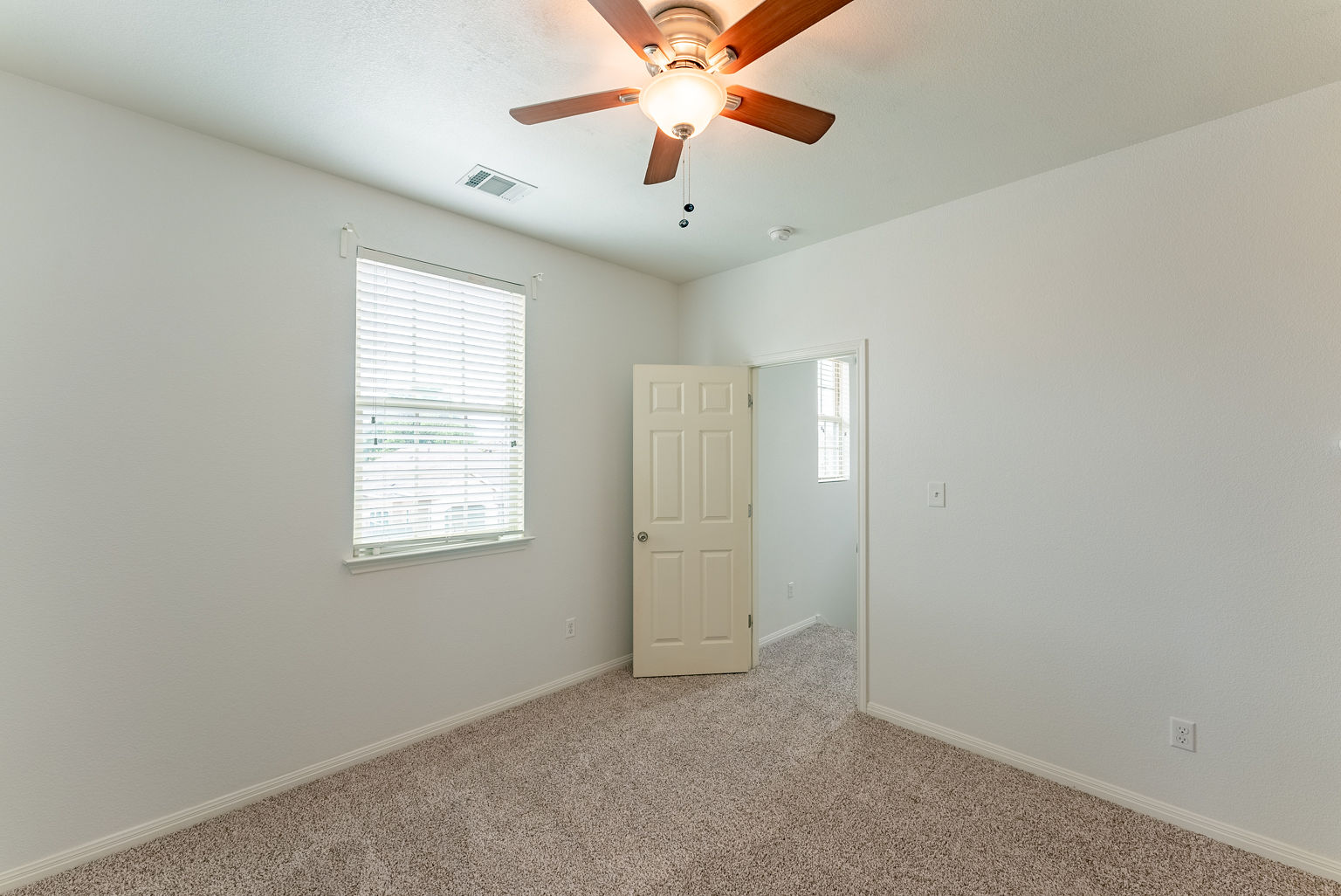 4514 Senda Lane Austin, TX 78725 - Photo 21 of 25 an empty room with windows and fan