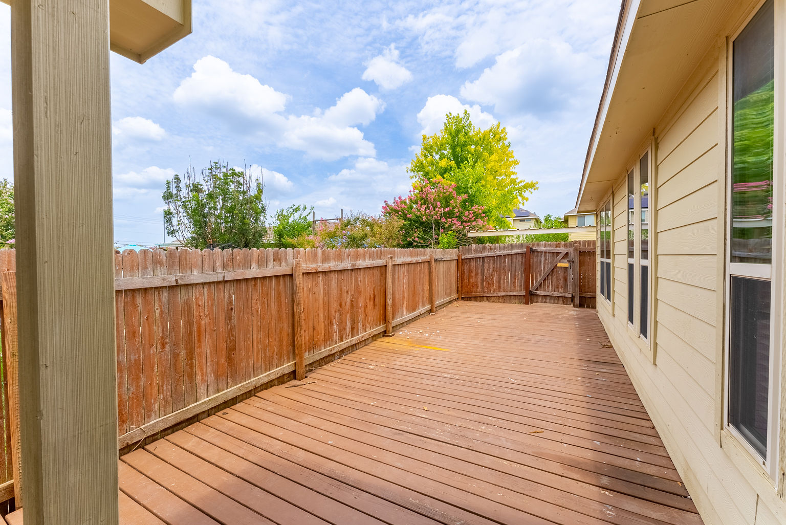 4514 Senda Lane Austin, TX 78725 - Photo 23 of 25 a view of a balcony with wooden floor and fence