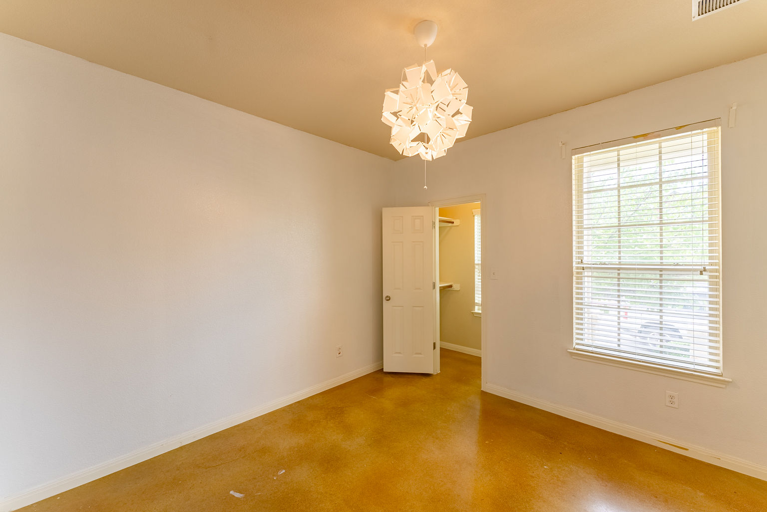 4514 Senda Lane Austin, TX 78725 - Photo 5 of 25 an empty room with a chandelier