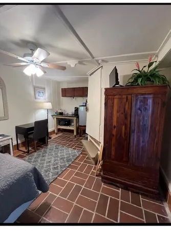 a living room with furniture a dining table and chairs with wooden floor