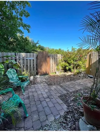 a view of a backyard with plants and a fountain