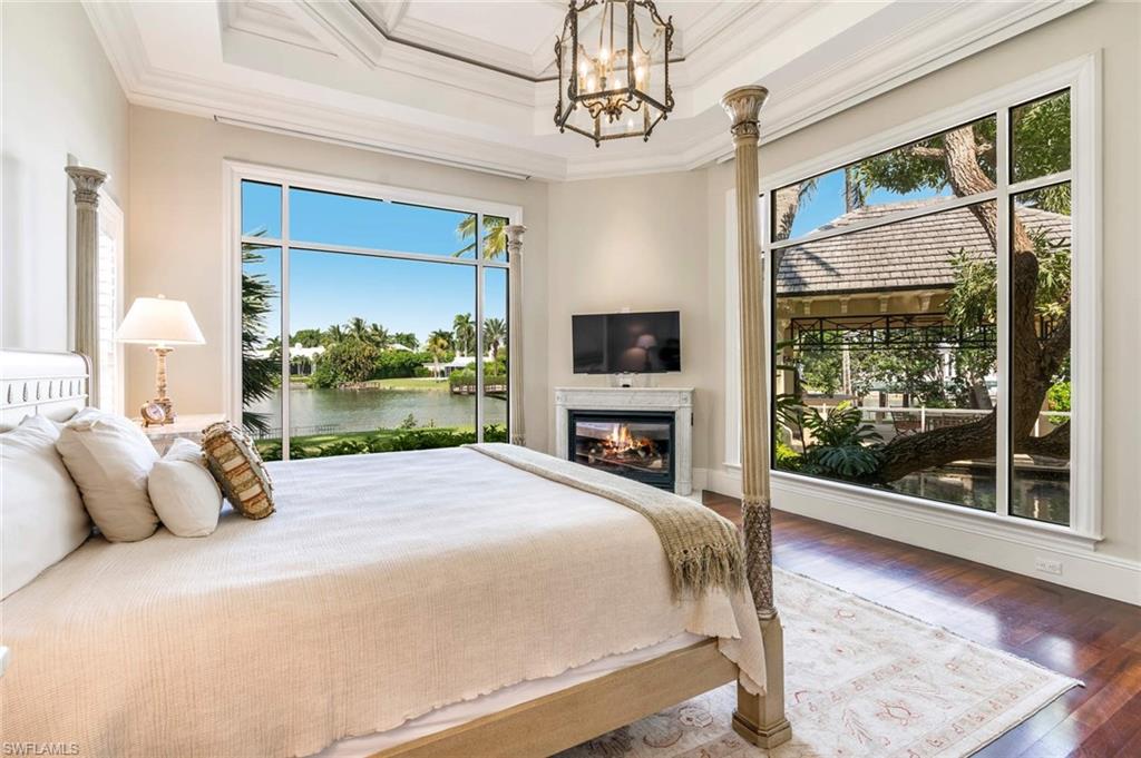 3275 Green Dolphin Lane Naples, FL 34102 - Photo 12 of 35 a bed sitting in a bedroom next to a window