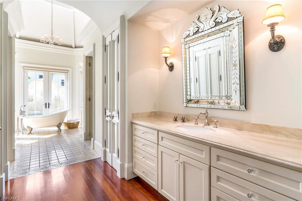 3275 Green Dolphin Lane Naples, FL 34102 - Photo 13 of 35 a en suite bathroom with a granite countertop sink and a mirror