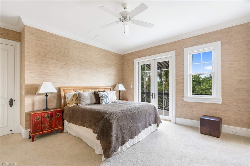 3275 Green Dolphin Lane Naples, FL 34102 - Photo 16 of 35 a bedroom with a bed and a chandelier