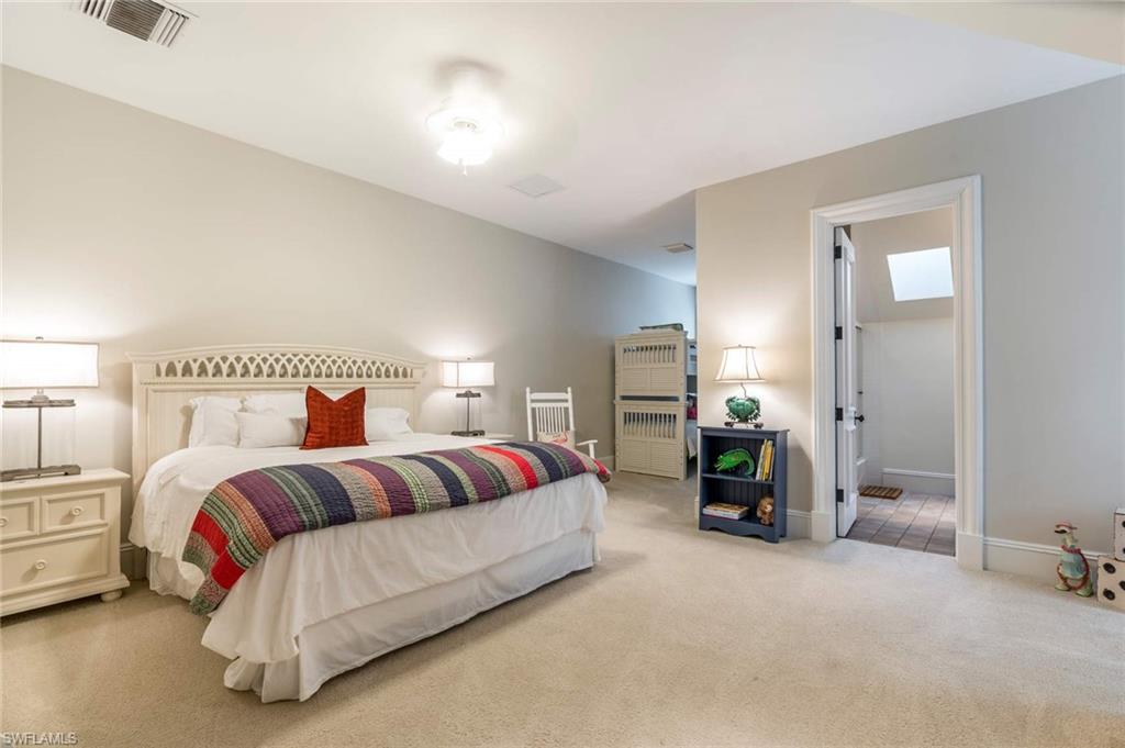 3275 Green Dolphin Lane Naples, FL 34102 - Photo 17 of 35 a spacious bedroom with a bed and lamp