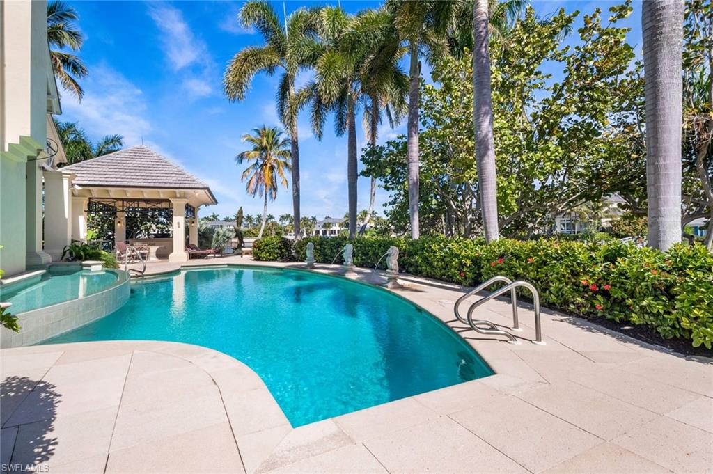 3275 Green Dolphin Lane Naples, FL 34102 - Photo 23 of 35 a view of a swimming pool with a patio