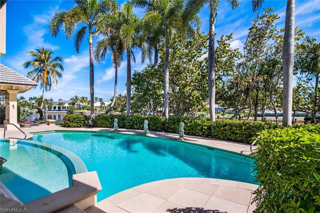 3275 Green Dolphin Lane Naples, FL 34102 - Photo 25 of 35 a view of a swimming pool and lounge chairs