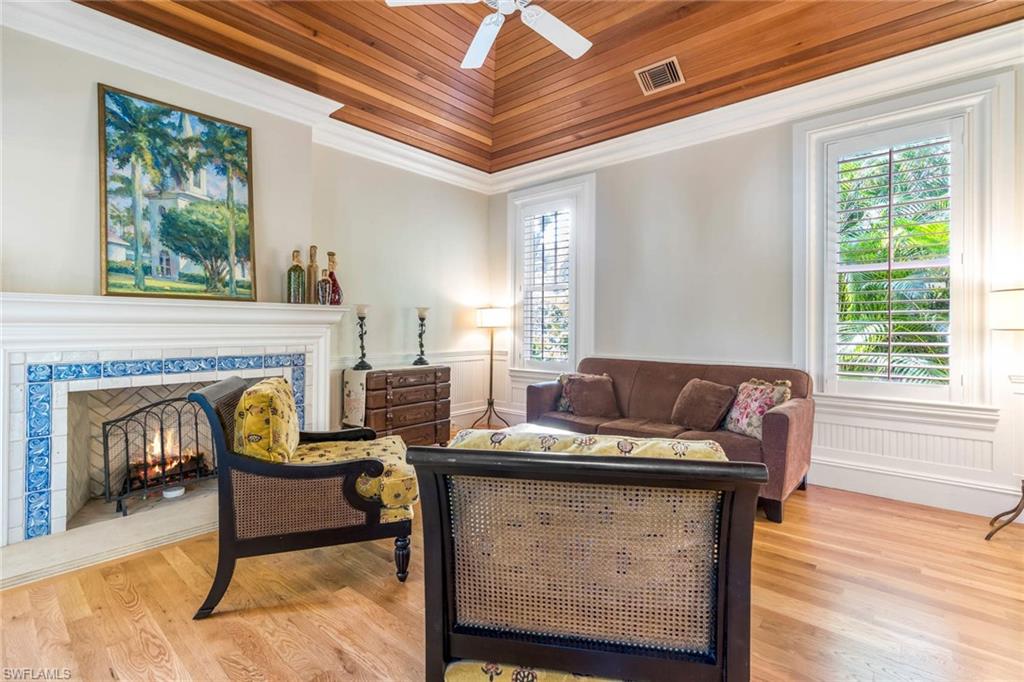 3275 Green Dolphin Lane Naples, FL 34102 - Photo 29 of 35 a living room with furniture and a fireplace