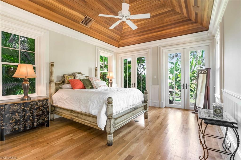 3275 Green Dolphin Lane Naples, FL 34102 - Photo 30 of 35 a bed sitting in a bedroom next to a window