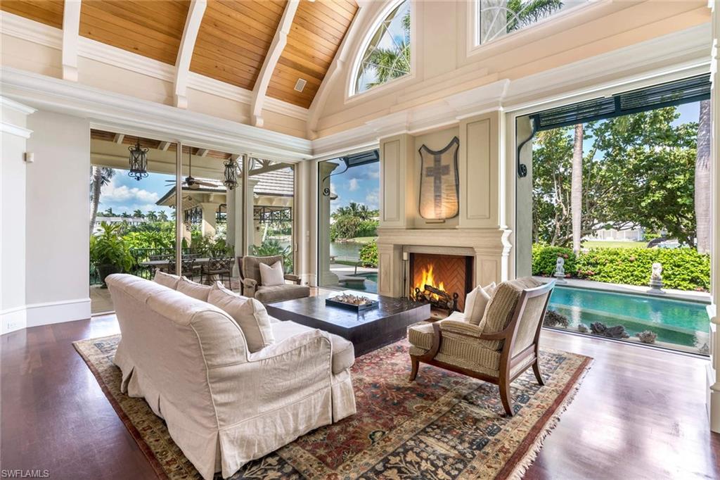 3275 Green Dolphin Lane Naples, FL 34102 - Photo 6 of 35 a living room with furniture and a fireplace