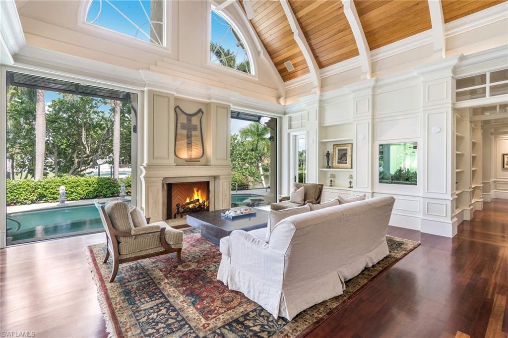 3275 Green Dolphin Lane Naples, FL 34102 - Photo 7 of 35 a living room with furniture and a fireplace