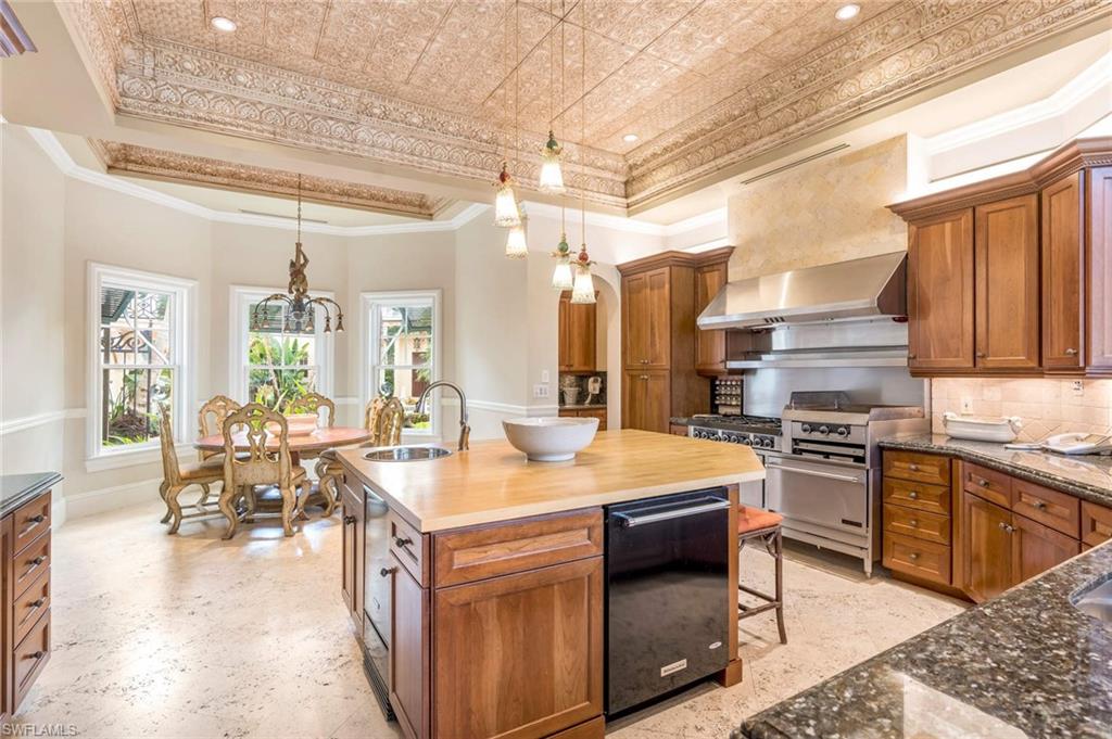 3275 Green Dolphin Lane Naples, FL 34102 - Photo 9 of 35 a kitchen with a stove a sink and a refrigerator