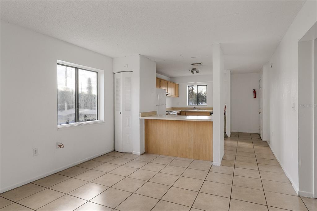 2547 Myrtle Avenue Sanford, FL 32773 - Photo 5 of 13 a kitchen with a refrigerator and white cabinets
