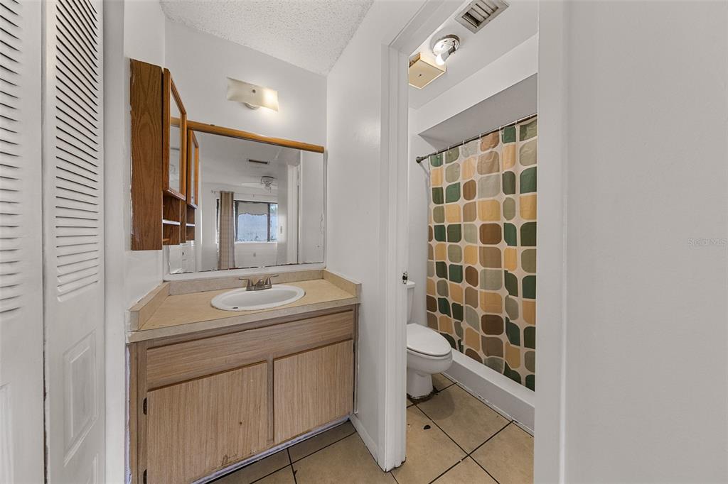 2547 Myrtle Avenue Sanford, FL 32773 - Photo 9 of 13 a bathroom with a sink toilet and shower