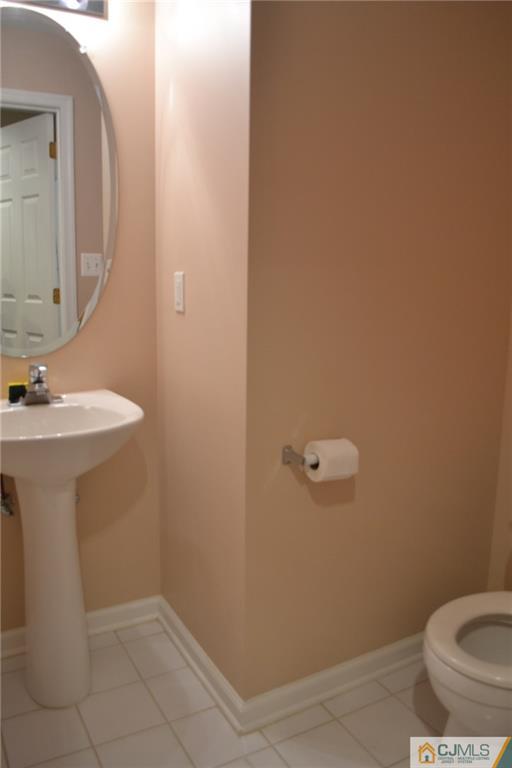 19 Dickerson Lane, Unit X Old Bridge, NJ 08857 - Photo 11 of 25 a bathroom with a sink a toilet and mirror
