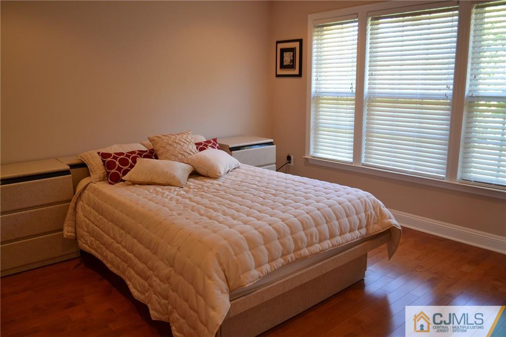 19 Dickerson Lane, Unit X Old Bridge, NJ 08857 - Photo 13 of 25 a bedroom with a bed and windows
