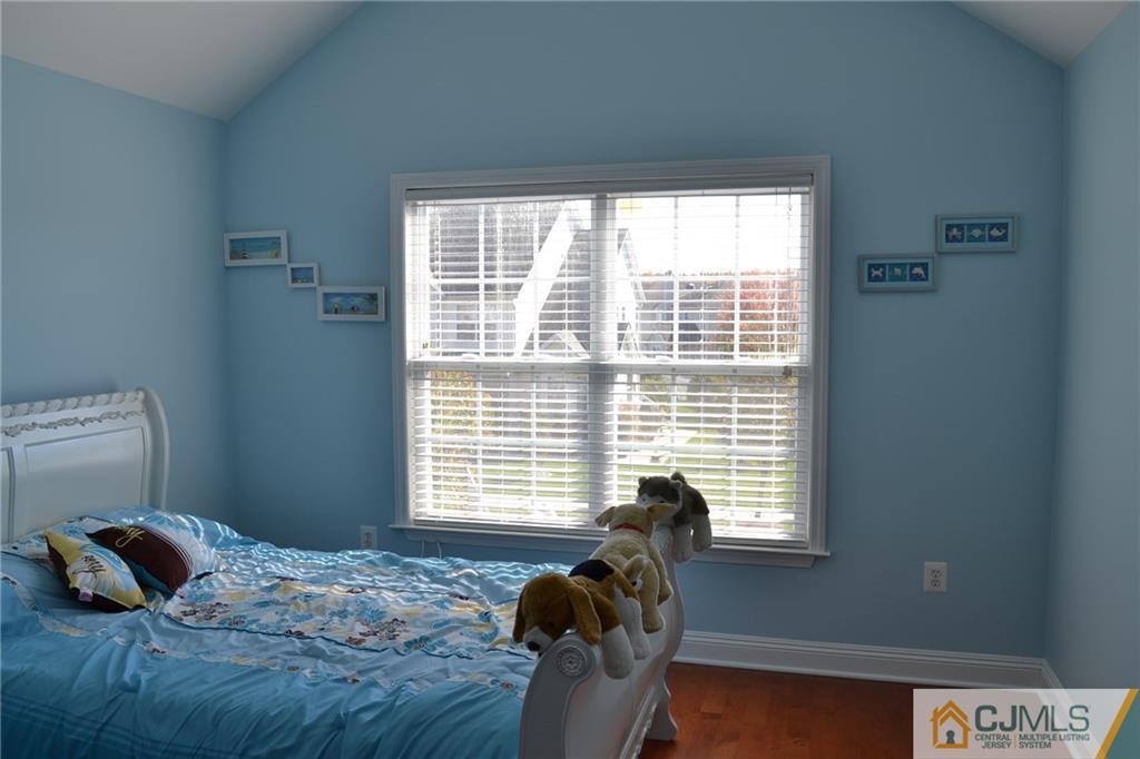 19 Dickerson Lane, Unit X Old Bridge, NJ 08857 - Photo 16 of 25 a bedroom with a bed and a window