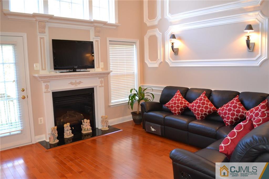 19 Dickerson Lane, Unit X Old Bridge, NJ 08857 - Photo 4 of 25 a living room with furniture fireplace and flat screen tv