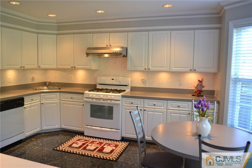 19 Dickerson Lane, Unit X Old Bridge, NJ 08857 - Photo 8 of 25 a kitchen with a stove a sink and cabinets
