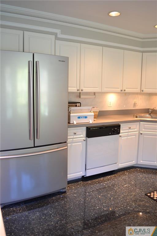 19 Dickerson Lane, Unit X Old Bridge, NJ 08857 - Photo 9 of 25 a kitchen with granite countertop white cabinets and refrigerator