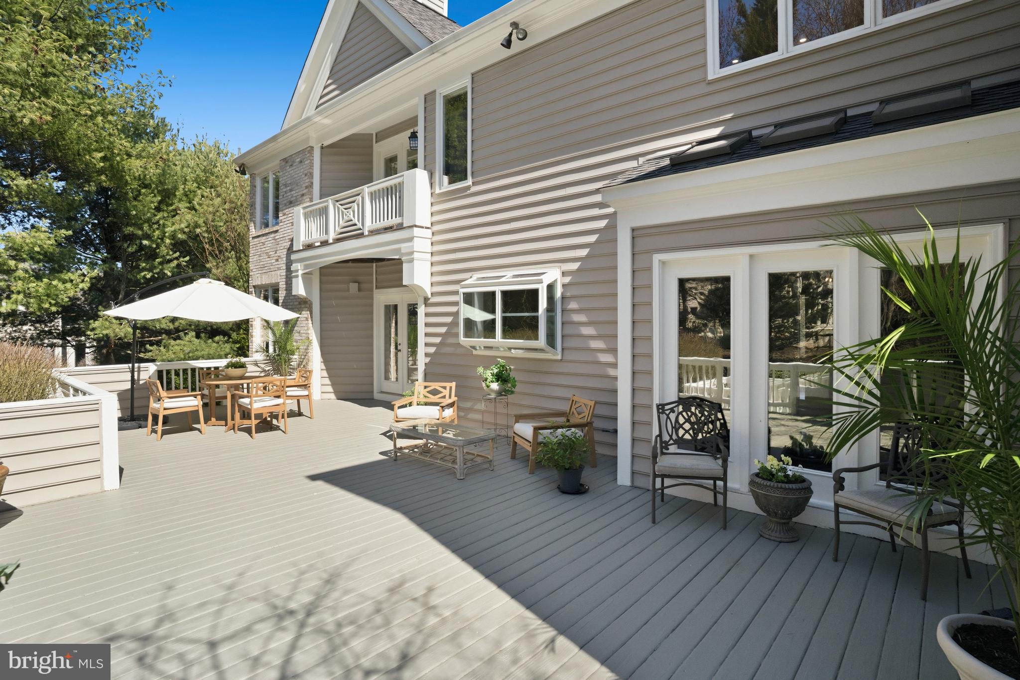 1156 Fieldview Drive Reston, VA 20194 - Photo 101 of 104 a view of a patio with table and chairs under an umbrella with wooden floor