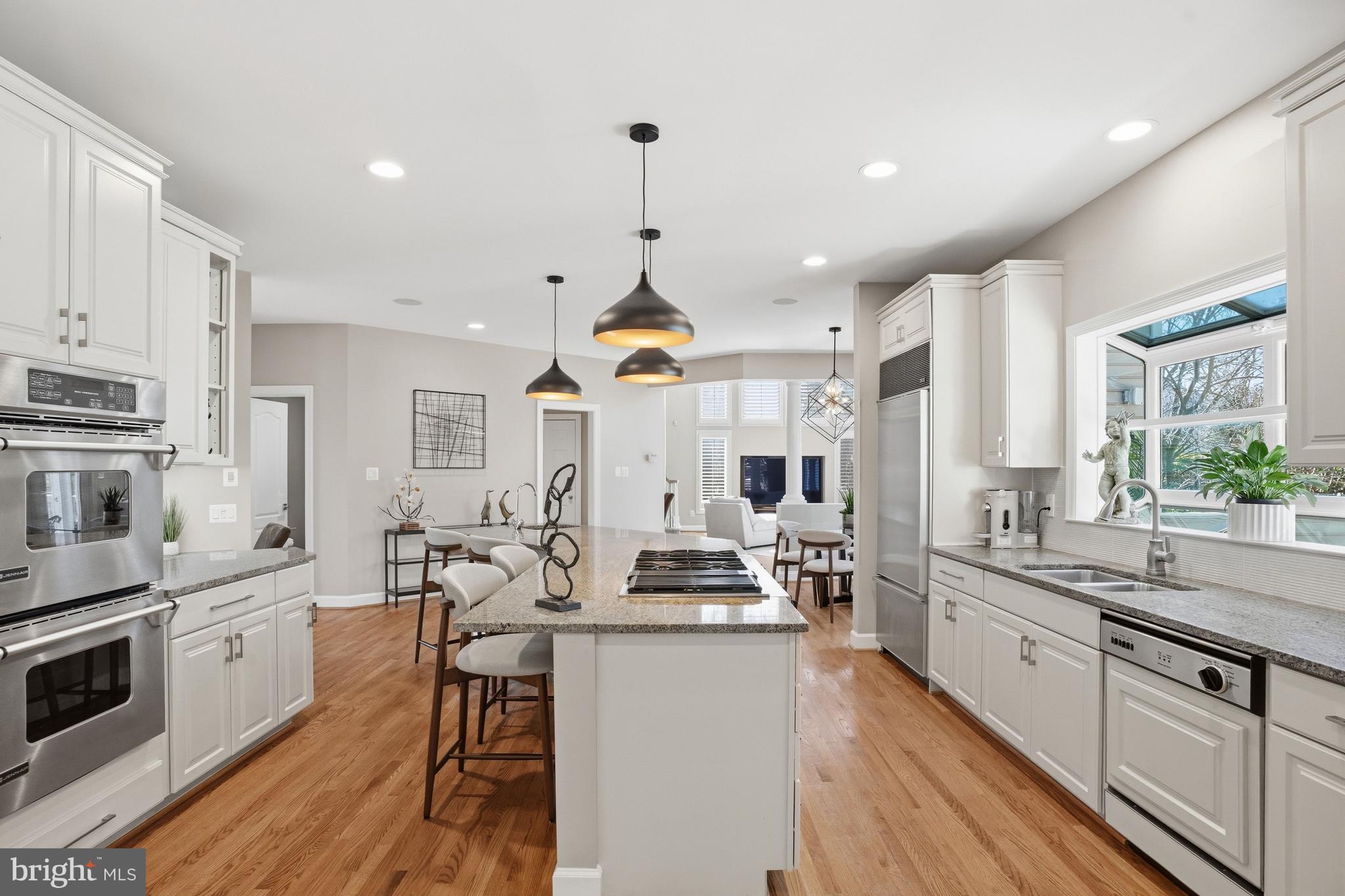 1156 Fieldview Drive Reston, VA 20194 - Photo 23 of 104 a kitchen with stainless steel appliances kitchen island granite countertop a stove a sink dishwasher and white cabinets with wooden floor