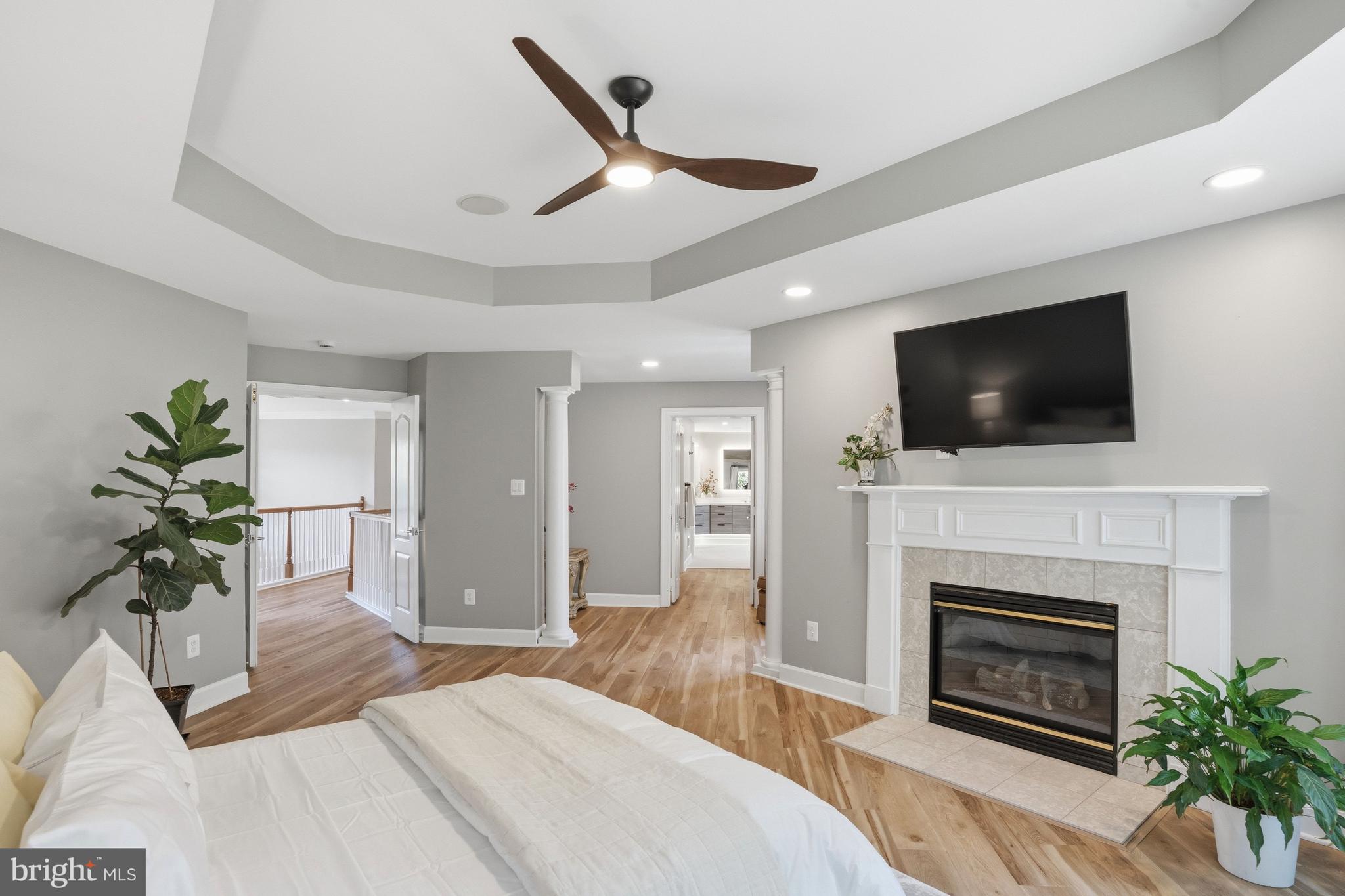 1156 Fieldview Drive Reston, VA 20194 - Photo 51 of 104 a bedroom with a bed a flat screen tv and a fireplace