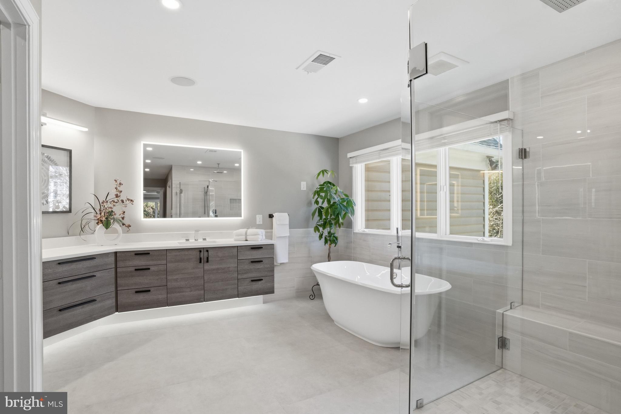 1156 Fieldview Drive Reston, VA 20194 - Photo 58 of 104 a spacious bathroom with a double vanity sink a large mirror and a bathtub