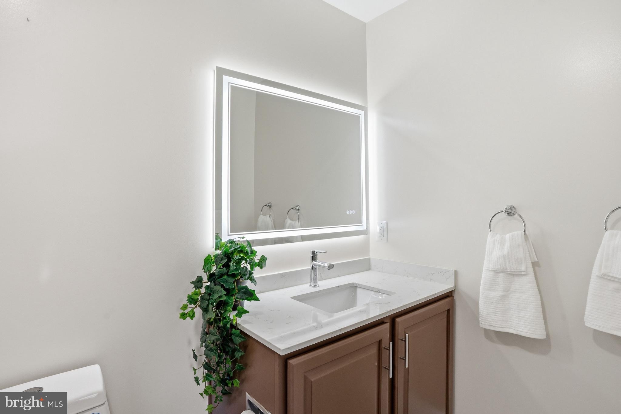 1156 Fieldview Drive Reston, VA 20194 - Photo 64 of 104 a bathroom with a sink a vanity and a mirror