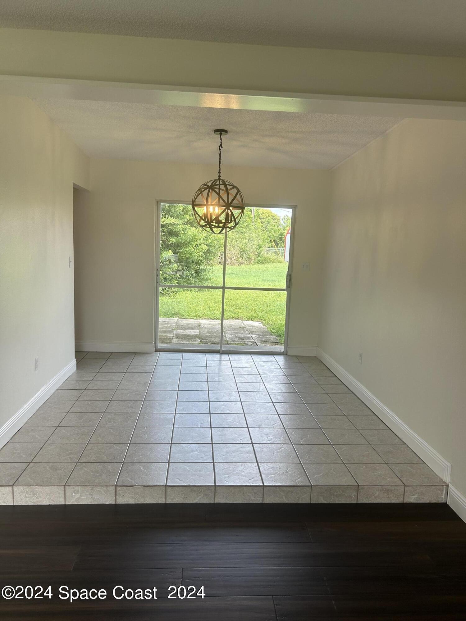 2808 Starlight Circle Northeast Palm Bay, FL 32905 - Photo 6 of 15 a view of a room with wooden floor and a fireplace