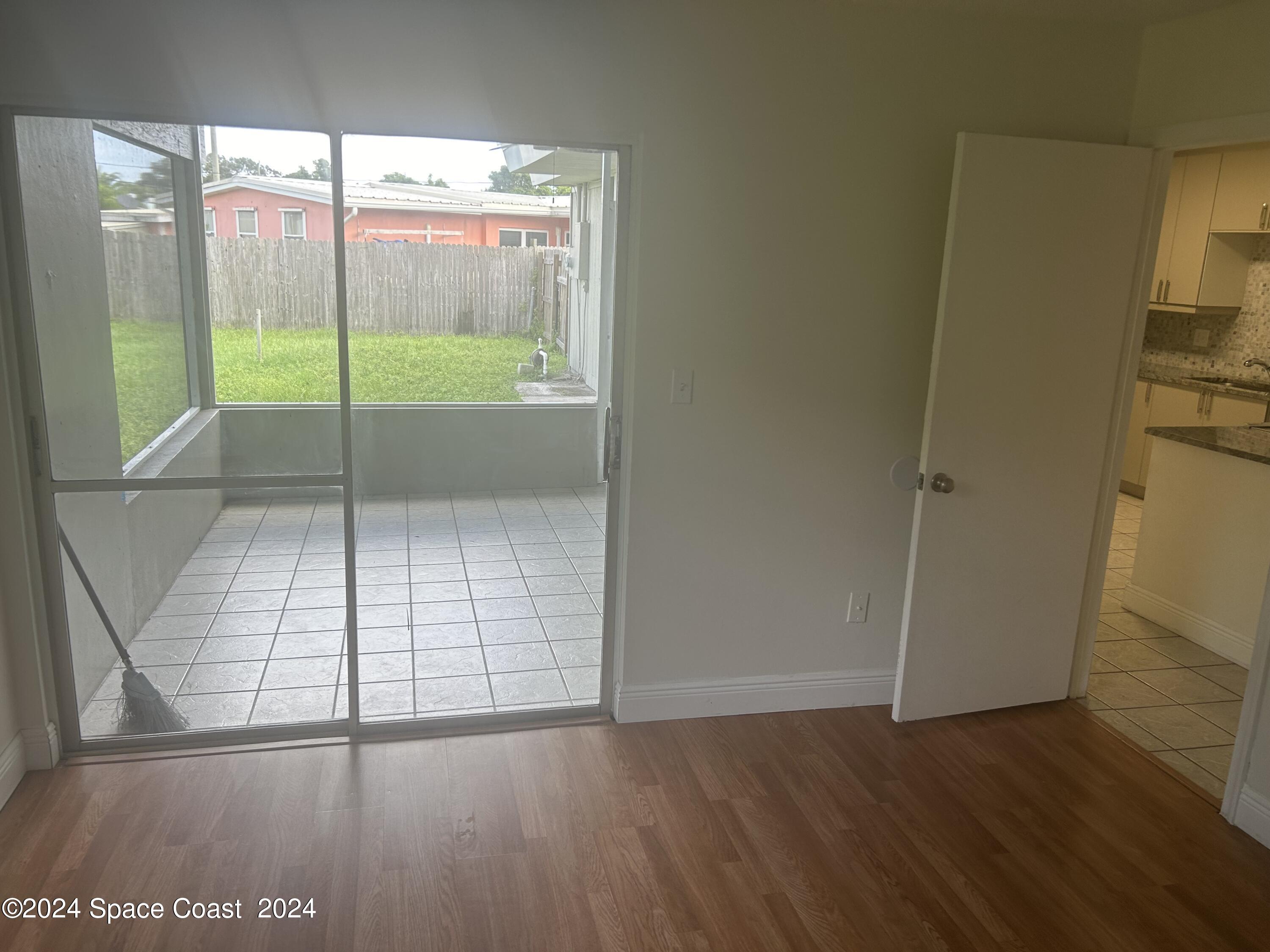 2808 Starlight Circle Northeast Palm Bay, FL 32905 - Photo 7 of 15 an empty room with wooden floor and windows