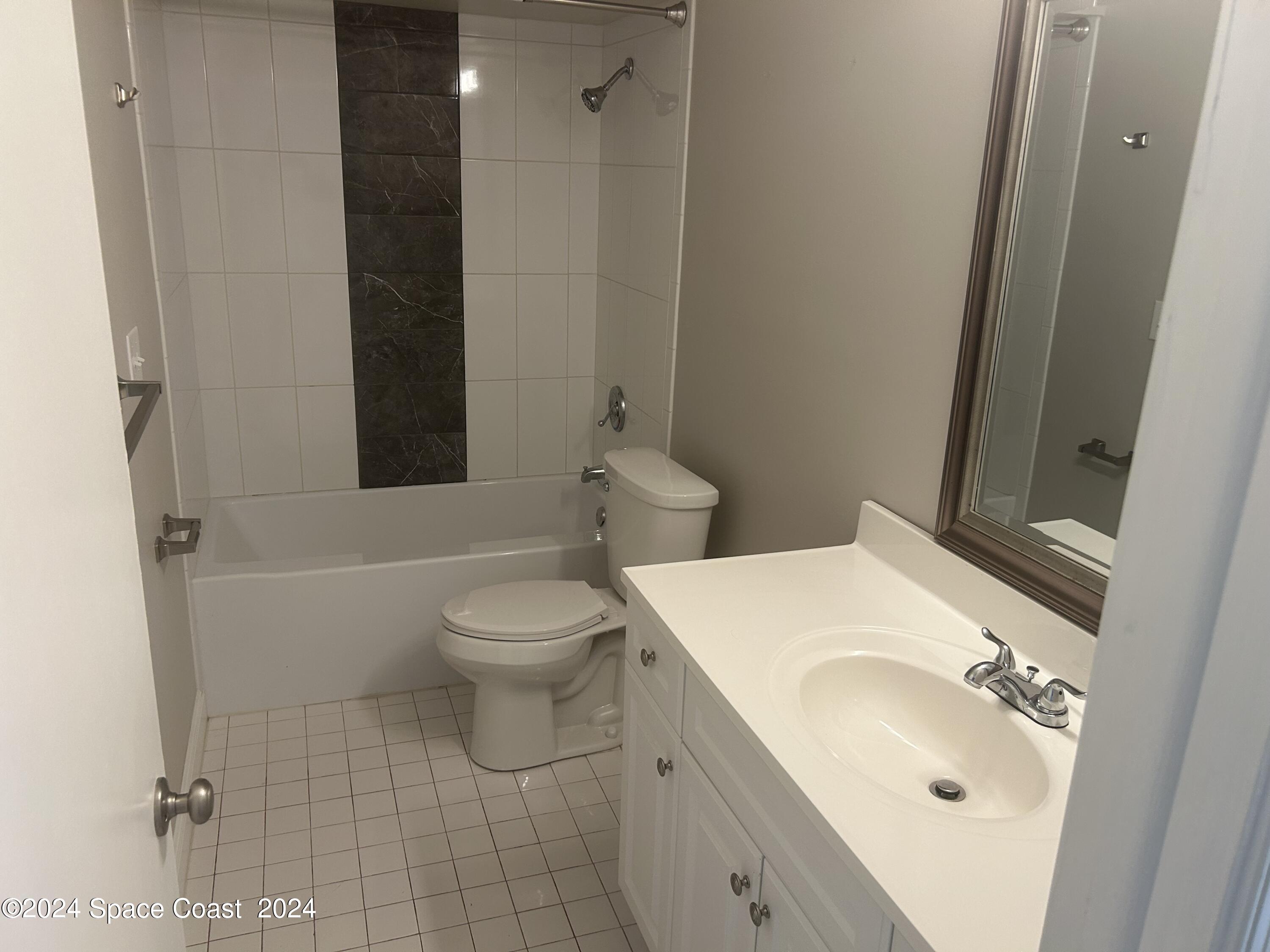 2808 Starlight Circle Northeast Palm Bay, FL 32905 - Photo 10 of 15 a bathroom with a sink toilet and shower