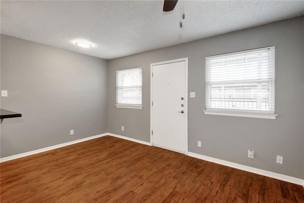 2401 Manor Road, Unit 127 Austin, TX 78722 - Photo 12 of 20 wooden floor in an empty room with a window