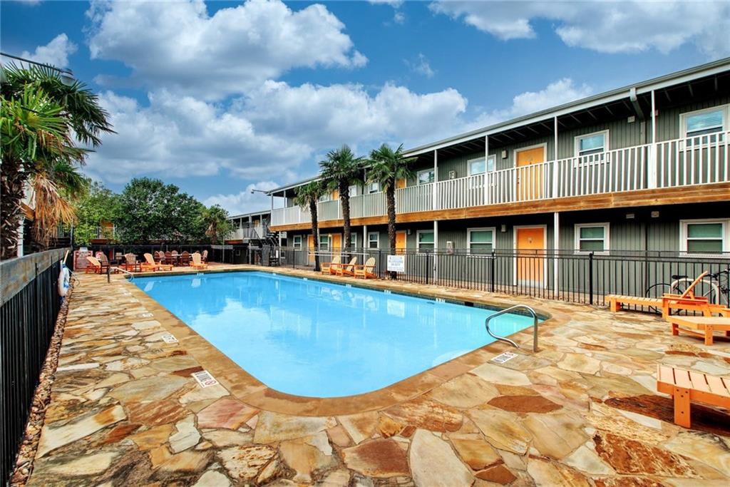 2401 Manor Road, Unit 127 Austin, TX 78722 - Photo 13 of 20 a view of a swimming pool with a lounge chairs