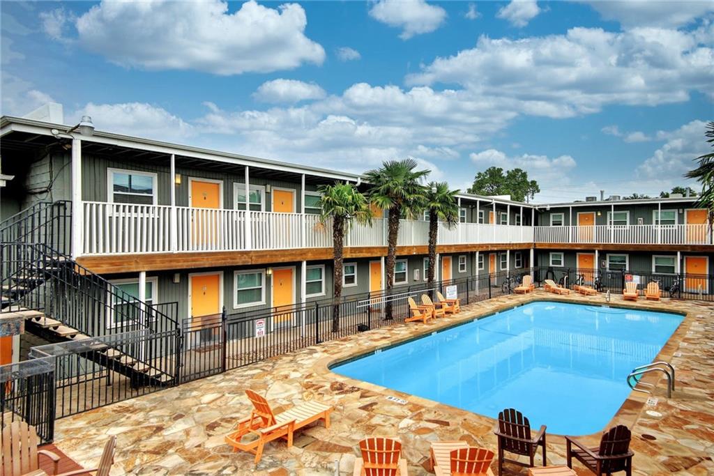 2401 Manor Road, Unit 127 Austin, TX 78722 - Photo 20 of 20 a front view of a house with swimming pool and seating