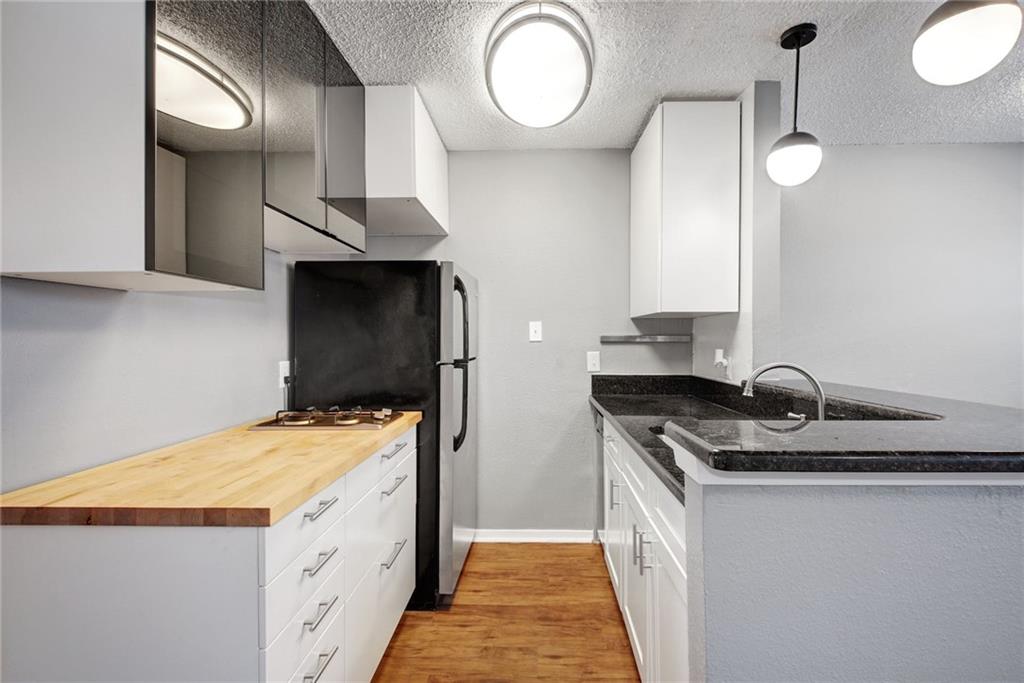 2401 Manor Road, Unit 127 Austin, TX 78722 - Photo 3 of 20 a kitchen that has a sink and a stove