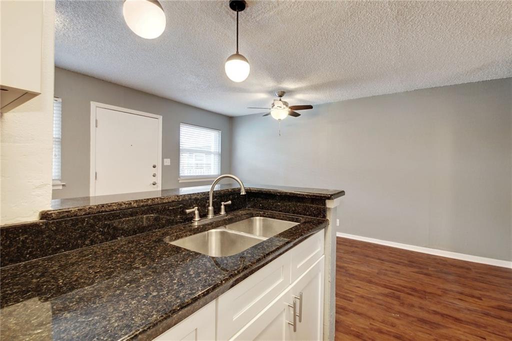 2401 Manor Road, Unit 127 Austin, TX 78722 - Photo 5 of 20 a bathroom with a sink a vanity and mirror