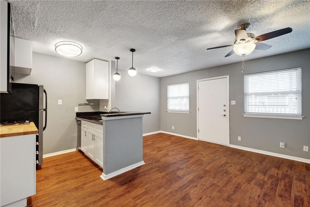 2401 Manor Road, Unit 127 Austin, TX 78722 - Photo 7 of 20 a view of kitchen with sink microwave and stove