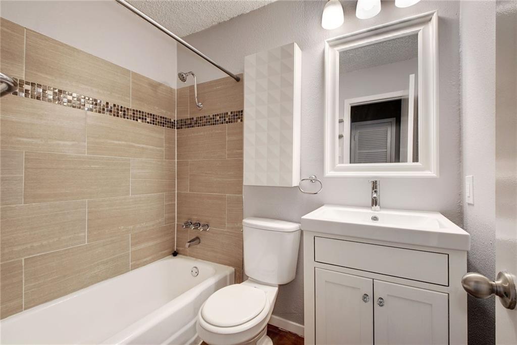 2401 Manor Road, Unit 127 Austin, TX 78722 - Photo 8 of 20 a bathroom with a sink a toilet and shower