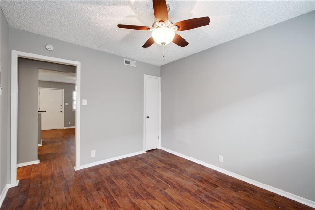 2401 Manor Road, Unit 127 Austin, TX 78722 - Photo 9 of 20 a view of an empty room with wooden floor