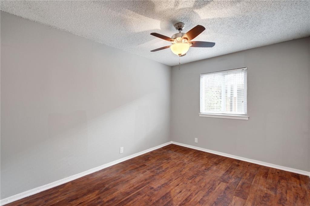 2401 Manor Road, Unit 127 Austin, TX 78722 - Photo 10 of 20 a view of an empty room with wooden floor and a window