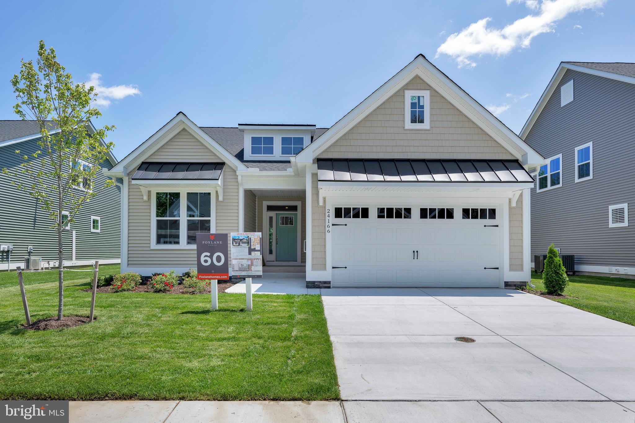 a front view of a house with a garden and plants